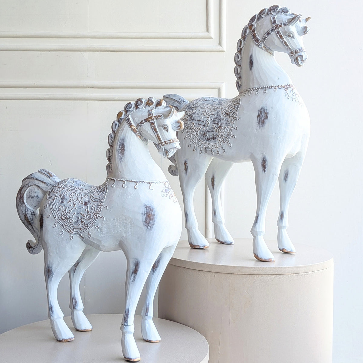 Large and small Regalia resin horse figurines with ornate saddle detailing