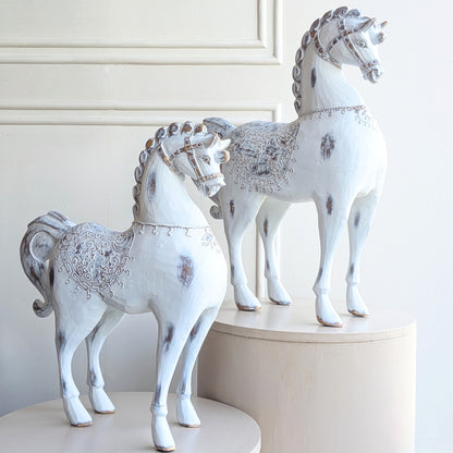Large and small Regalia resin horse figurines with ornate saddle detailing
