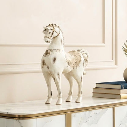 Regalia white horse figurine styled on a console with books in a refined interior