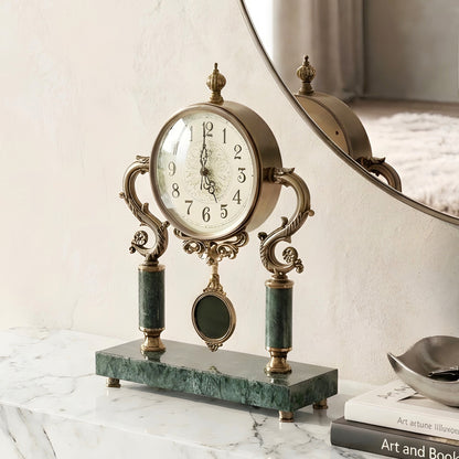 Regency marble and metal table clock styled on an entryway console beneath a mirror