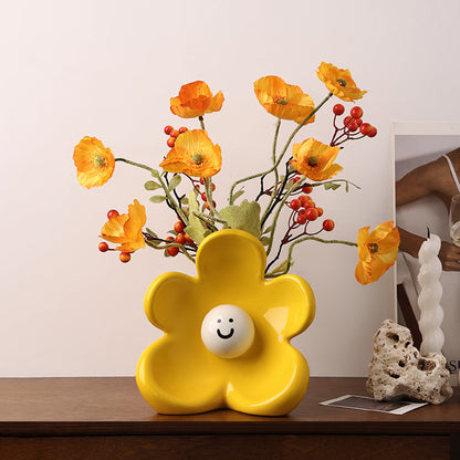 Solara yellow ceramic flower vase styled on a console