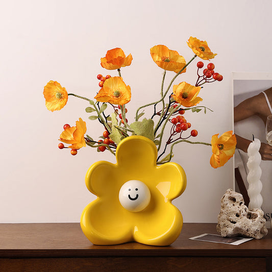Solara yellow ceramic flower vase styled on a console