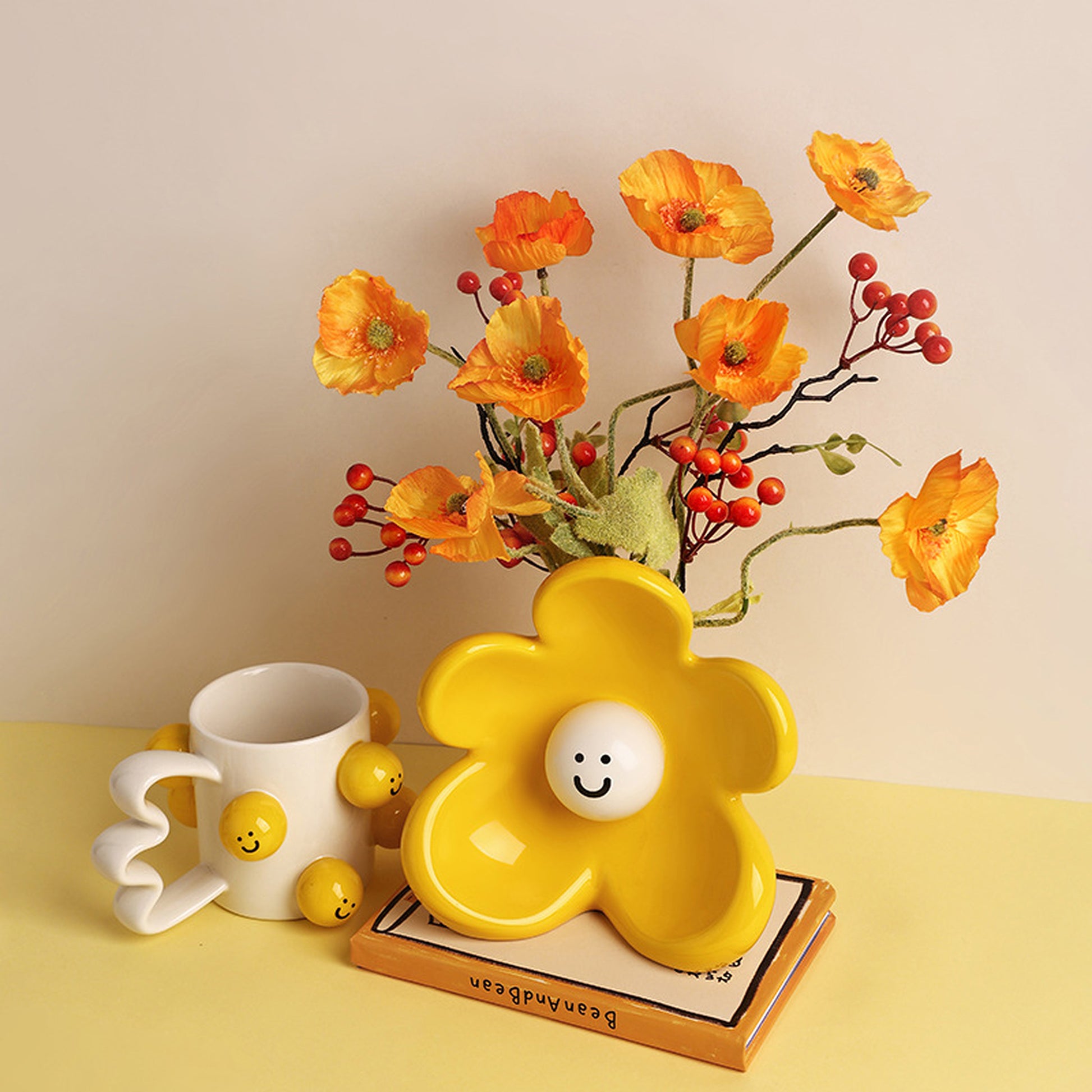 Solara yellow ceramic flower vase styled with orange blooms