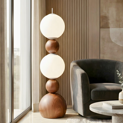 Solstice designer floor lamp styled beside a charcoal lounge chair
