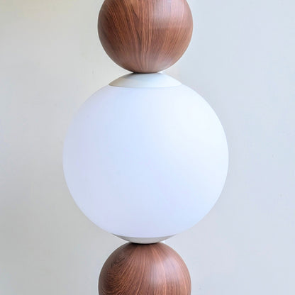 Close-up of the Solstice frosted glass globe and wood-grain metal detail
