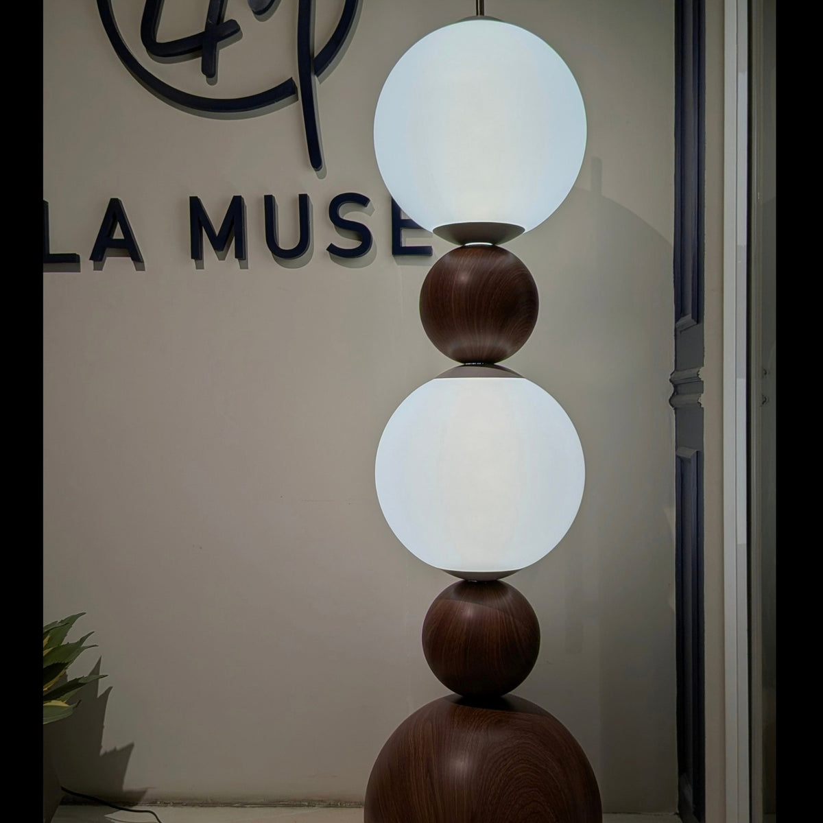 Solstice glass globe floor lamp glowing in an evening interior