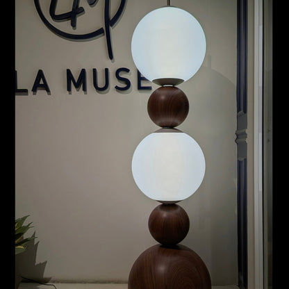Solstice glass globe floor lamp glowing in an evening interior