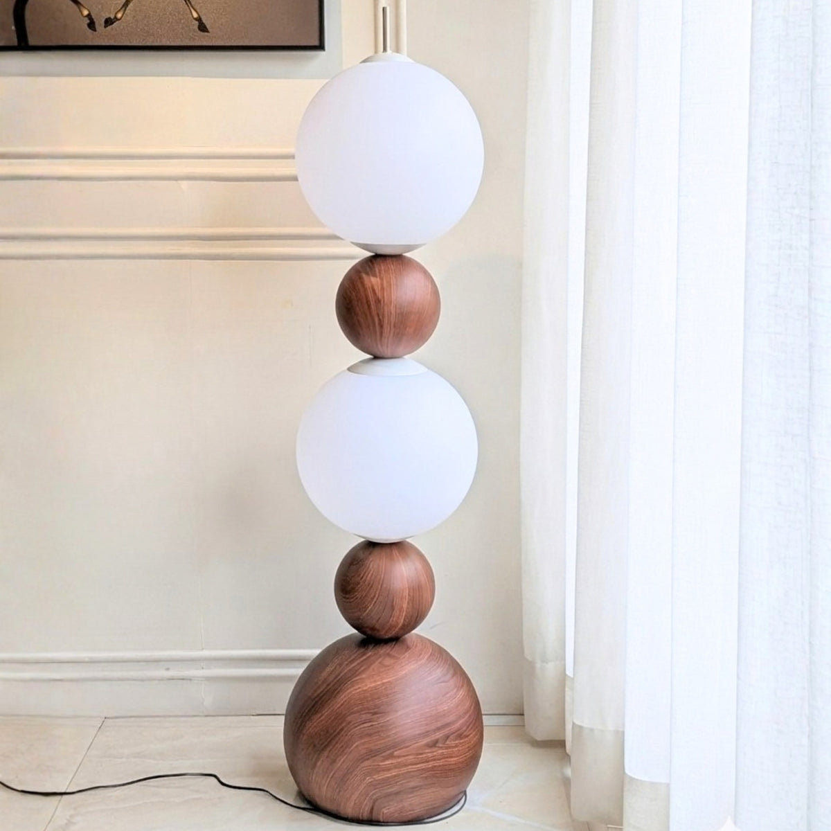 Solstice floor lamp full view with a stacked spherical silhouette and power cord