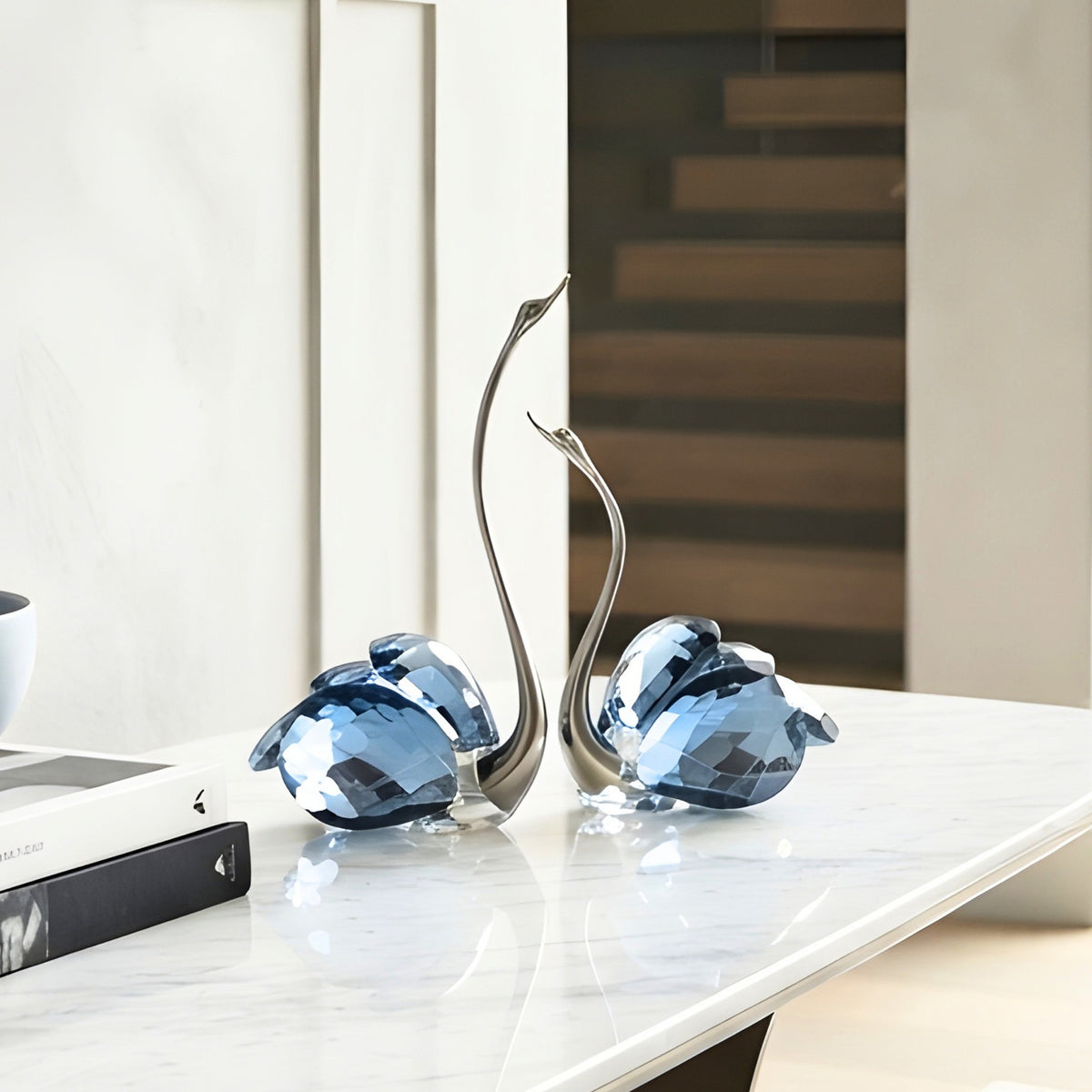 Soulmates blue crystal swan duo styled on a marble centre table