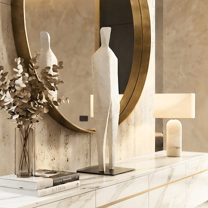 Stature white abstract sculpture styled on a foyer console beneath a round mirror