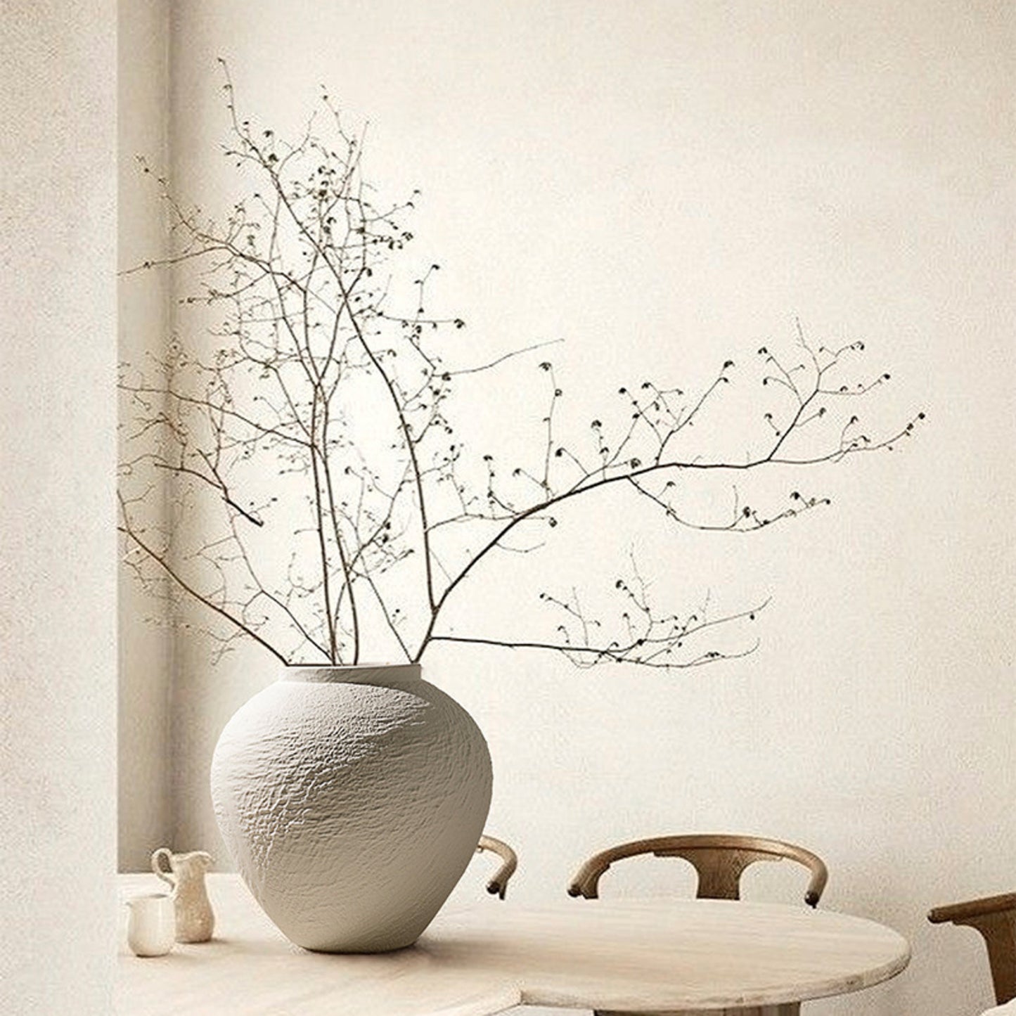 Strata small rounded white ceramic vase styled on a dining table