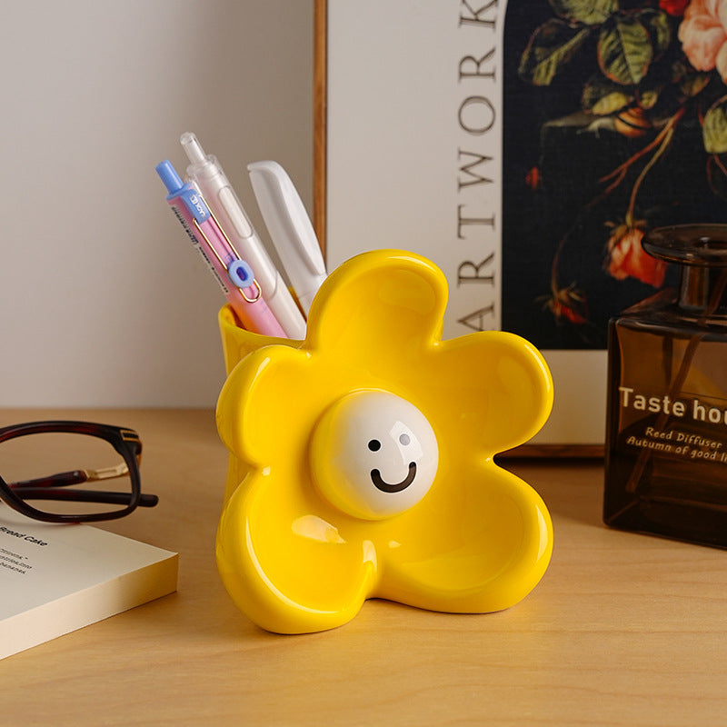 Sunny yellow ceramic vase and organizer styled on an office desk