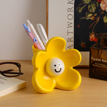 Sunny yellow ceramic vase and organizer styled on an office desk