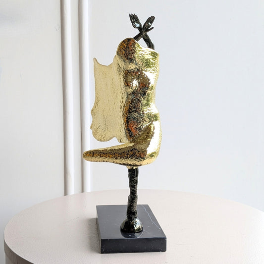 Sway metal lady figurine side view on black marble base