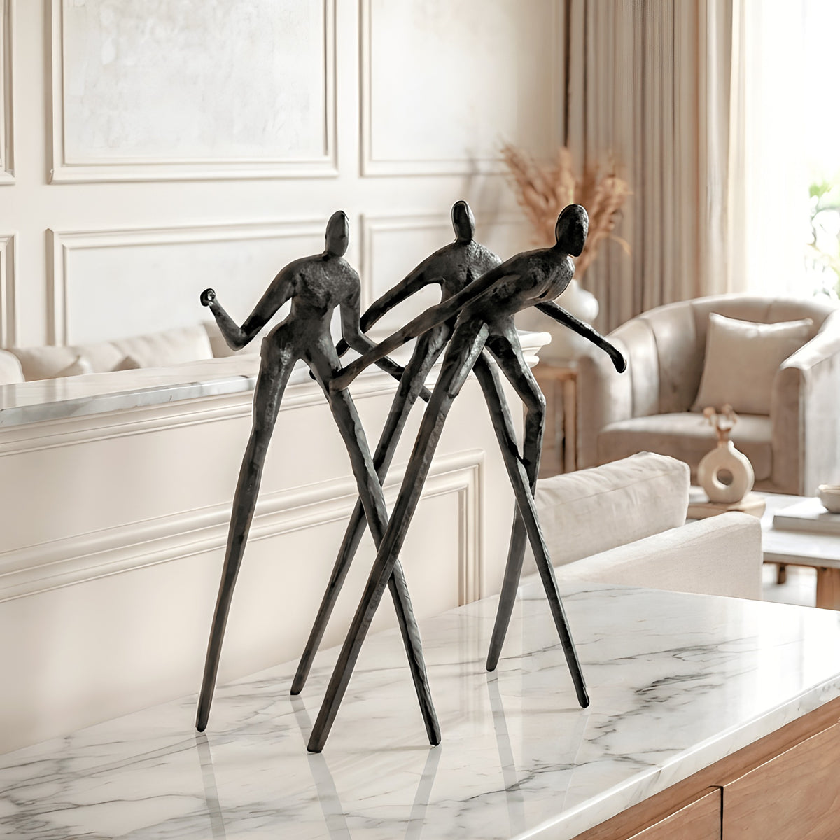 Synergy metal human figurine styled on a marble console in a luxury living room