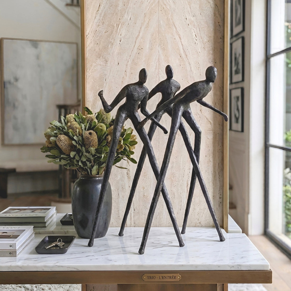 Luxury entryway console styled with Synergy metal human figurine showpiece