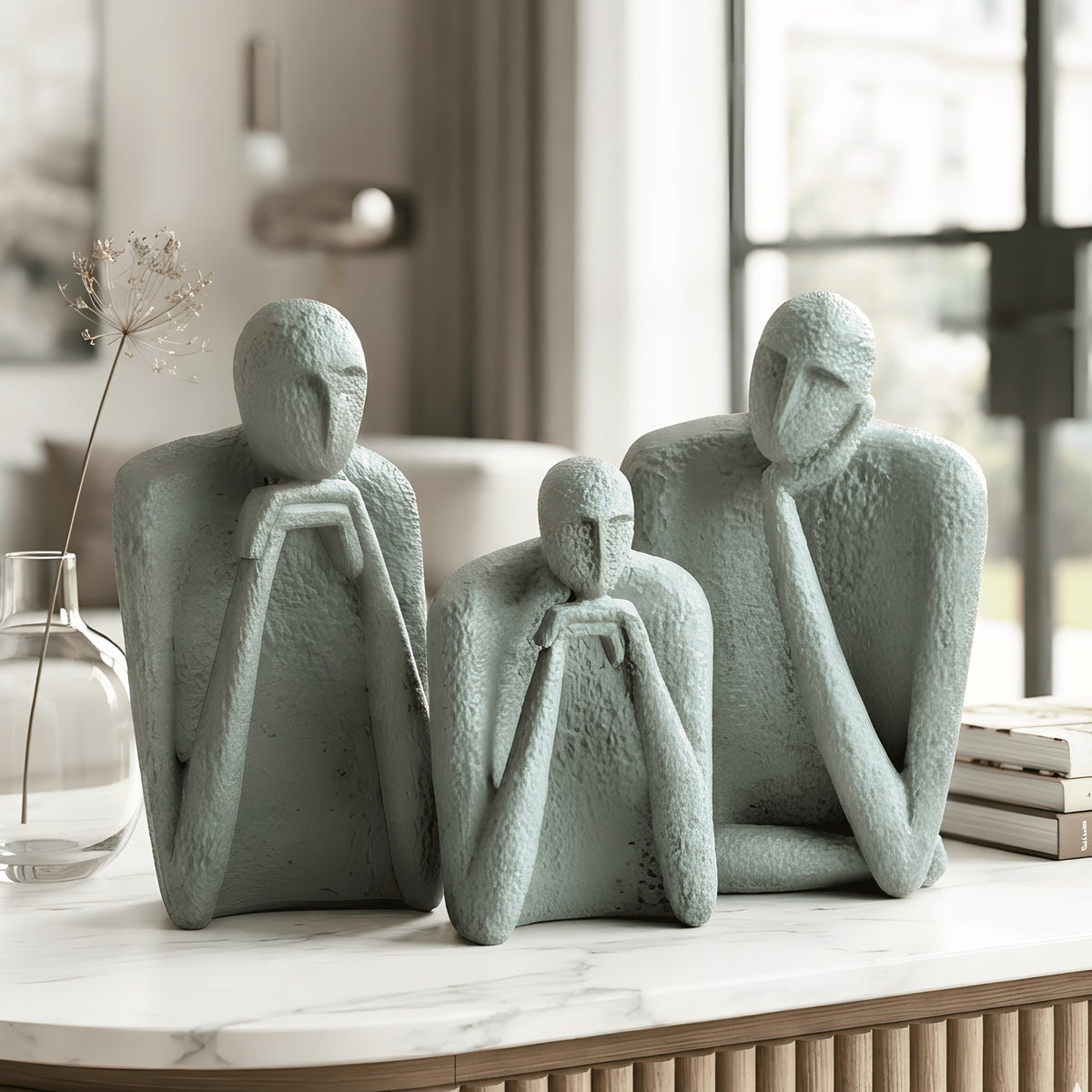 The Contemplatives abstract human figure set styled on a marble console