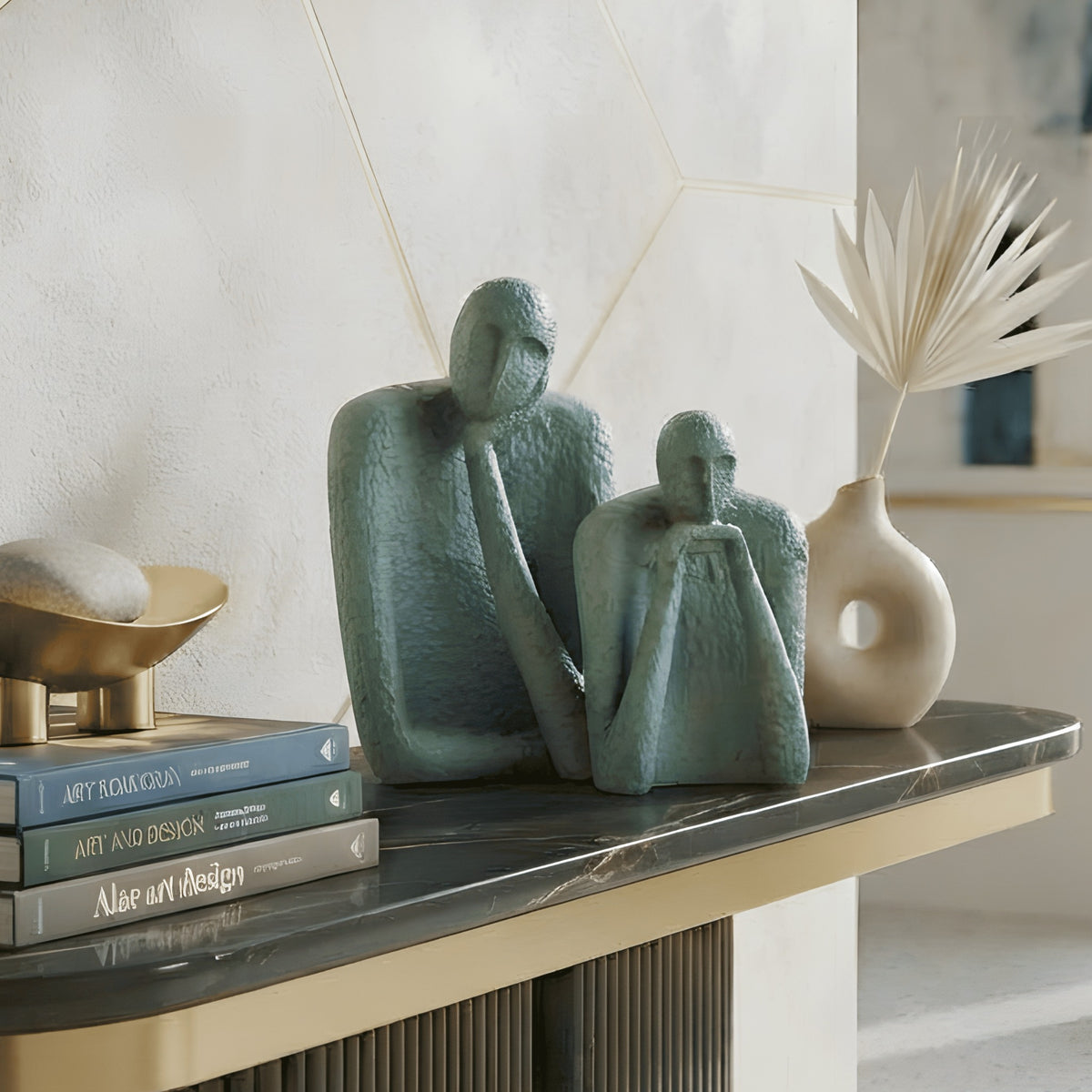The Contemplatives abstract figurines styled with books on a black console