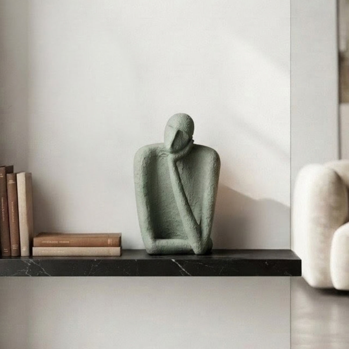 Single textured resin figure from The Contemplatives styled on a display shelf