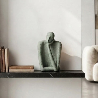 Single textured resin figure from The Contemplatives styled on a display shelf
