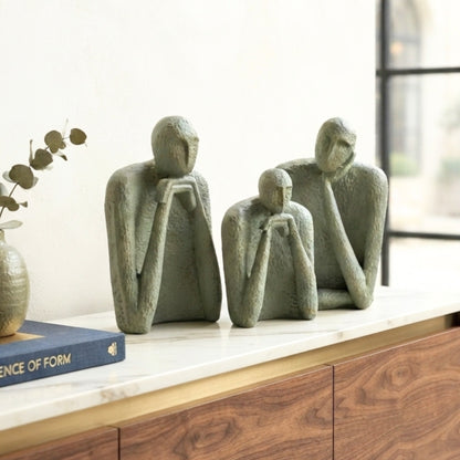 The Contemplatives textured resin figurines styled on a wooden sideboard