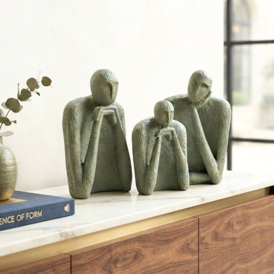 The Contemplatives textured resin figurines styled on a wooden sideboard