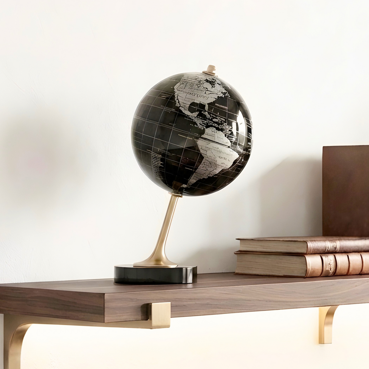 The World metal globe showpiece styled on a wooden shelf