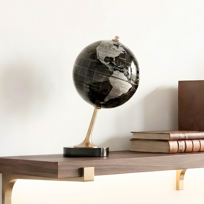 The World metal globe showpiece styled on a wooden shelf