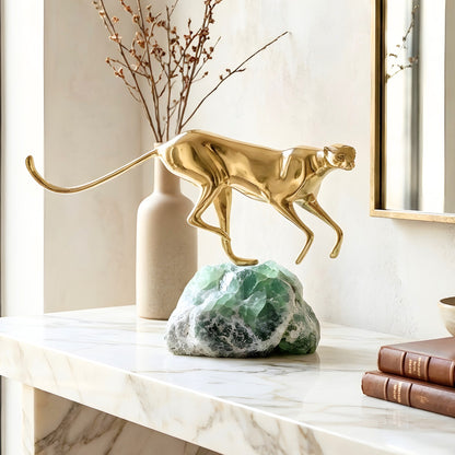 Velocity brass running big cat sculpture on green natural stone for luxury entryway consoles