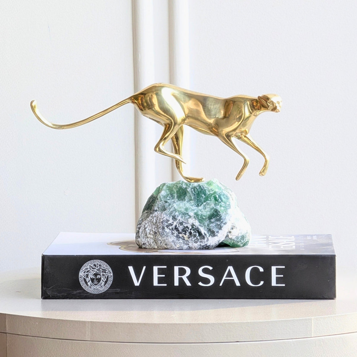 Velocity brass wildlife sculpture on green natural stone for luxury living room and console styling, view 3