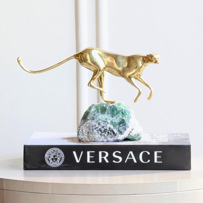 Velocity brass wildlife sculpture on green natural stone for luxury living room and console styling, view 3