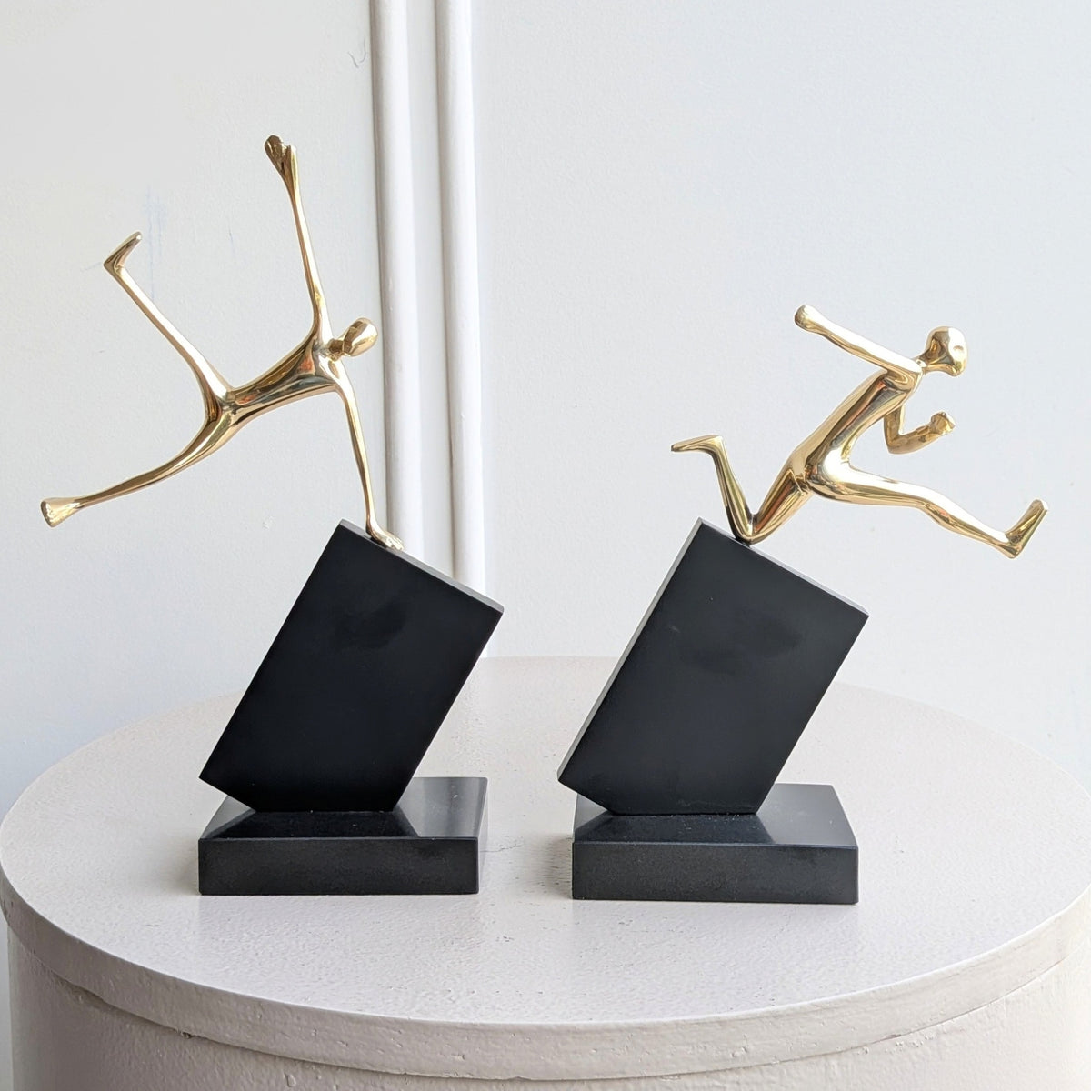Velocity running and jumping human figurine showpieces front view