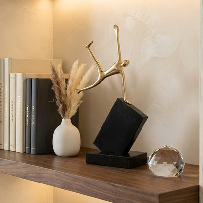 Velocity Jumping gold-tone figurine styled on a console shelf