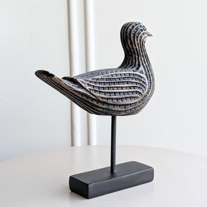 Black resin bird sculpture on a metal stand for table decor