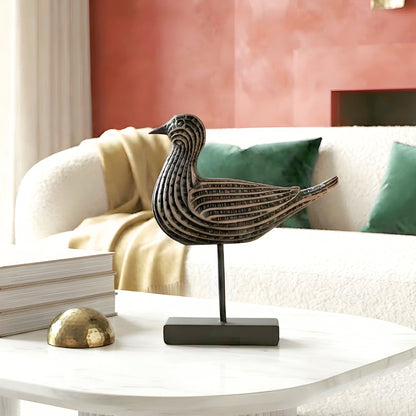 Resin and metal bird figurine for a curated living room interior