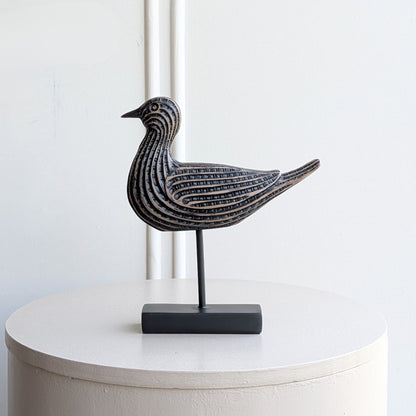 Black and antique-bronze resin bird showpiece on a metal stand for console table decor