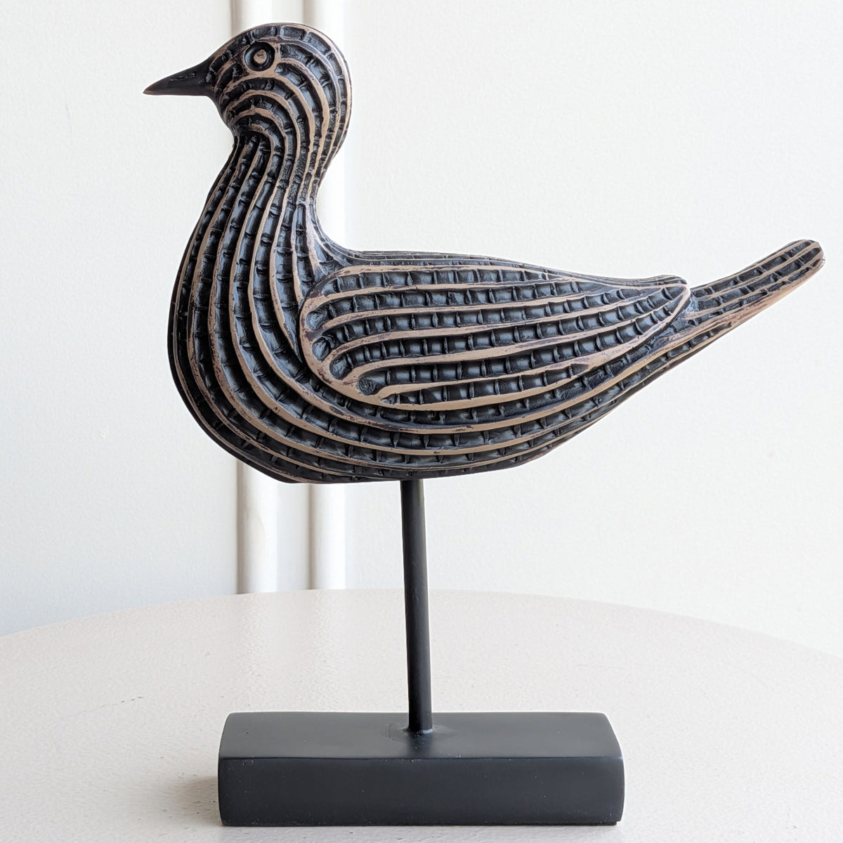 Close-up of antique bronze textured resin bird showpiece detailing
