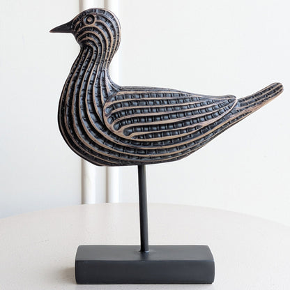 Close-up of antique bronze textured resin bird showpiece detailing